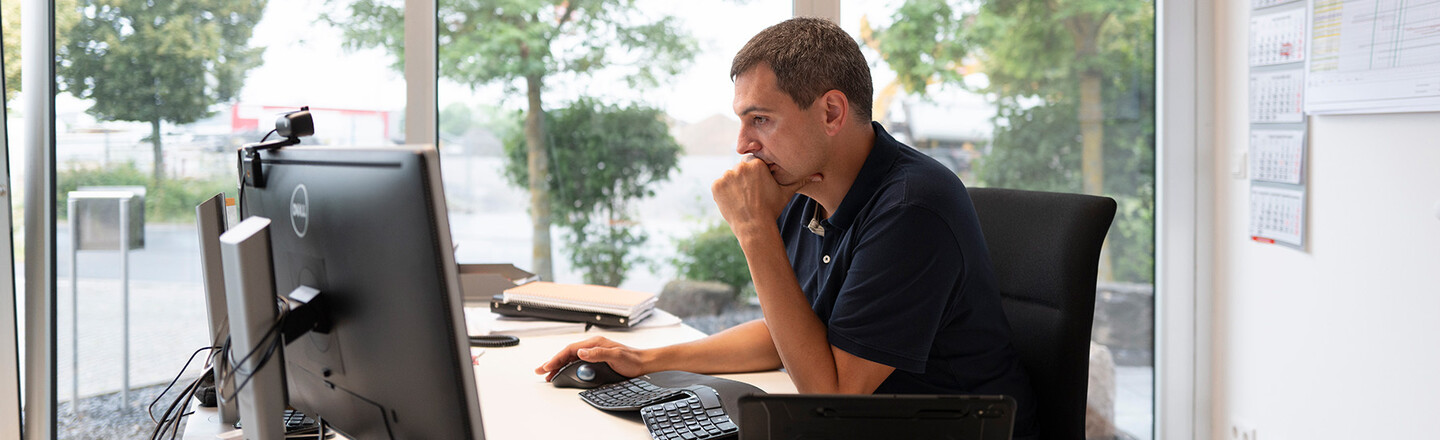 Lightning protection specialist sits thoughtfully at the PC